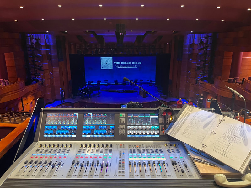 Mixing console at The Kennedy Center Terrace Theatre with the stage in the background.